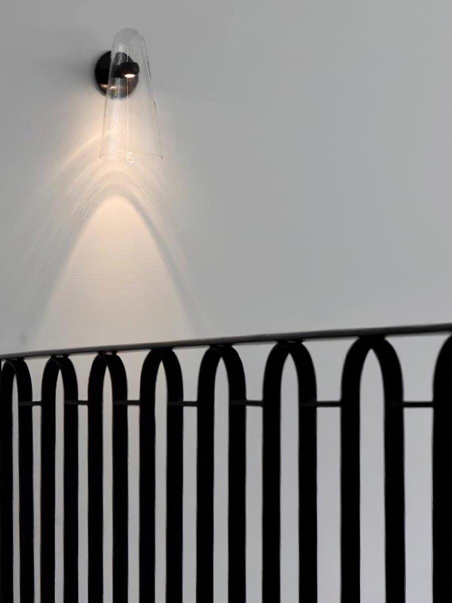 Conical wall light above a stair railing