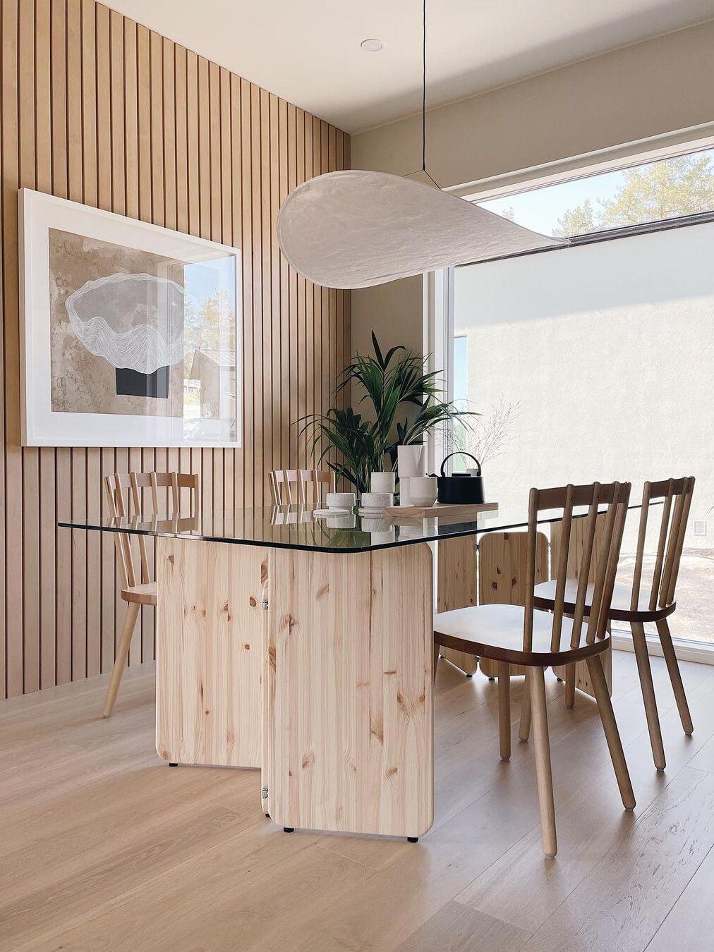 White pendant above a desk and wood wall panels