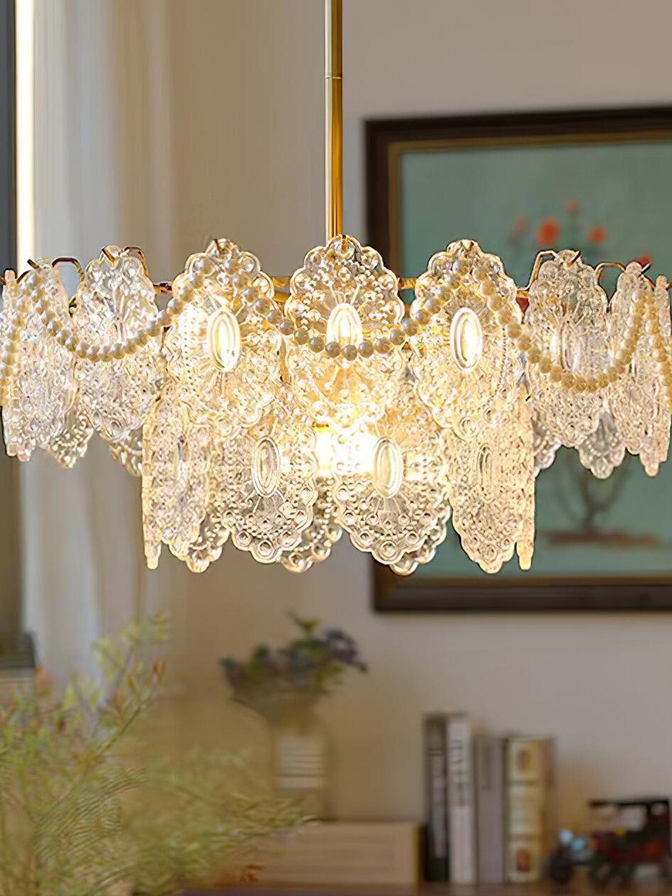 Gold chandelier with bead swags above room furnishings