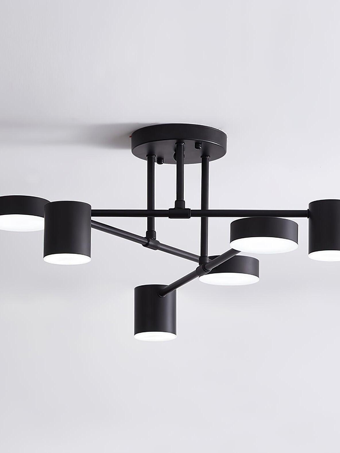 Close view of a black six-head ceiling light with glowing round faces, crossed arms and matching round canopy
