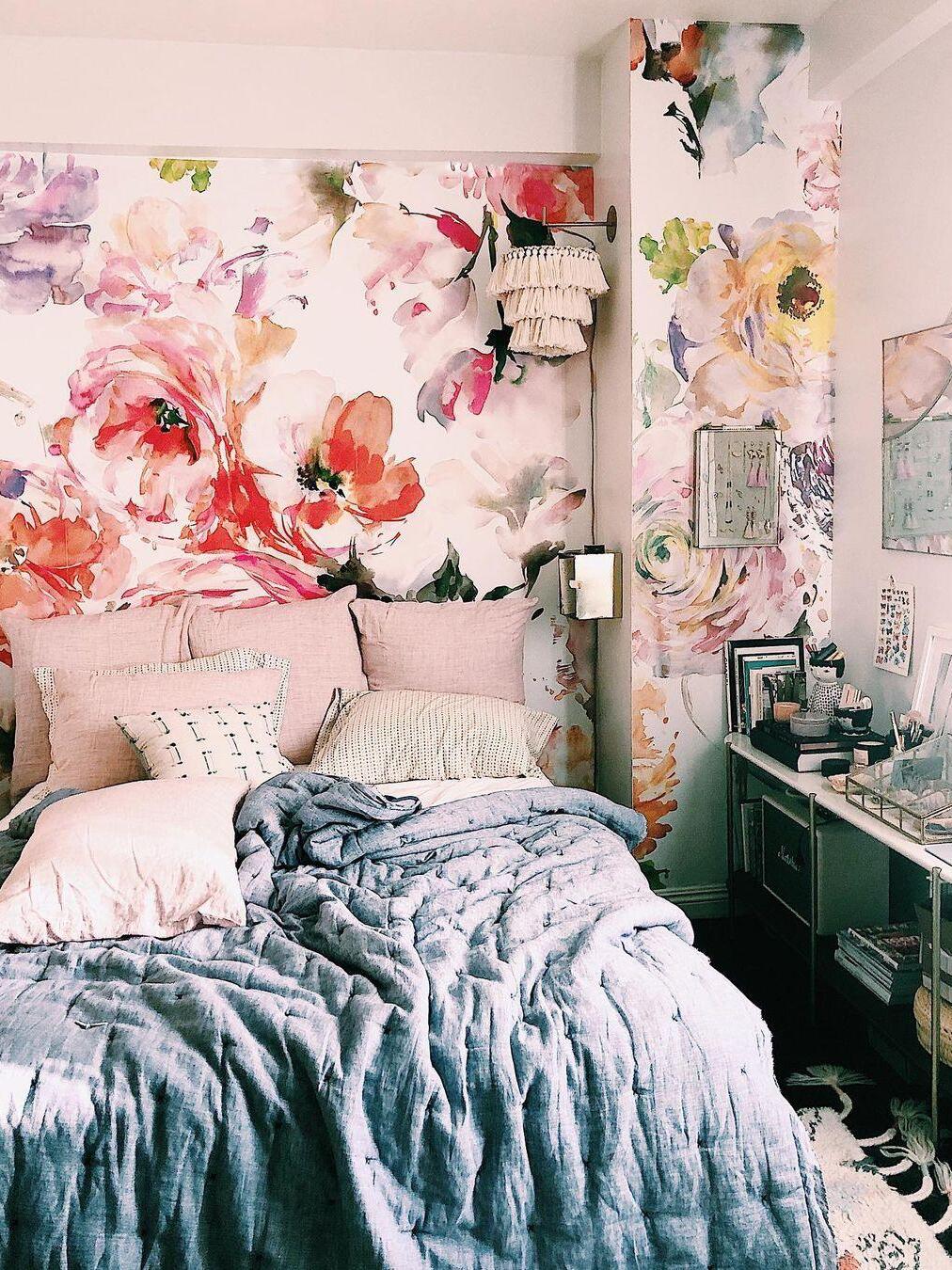 Blue tassel light shown against floral wallpaper