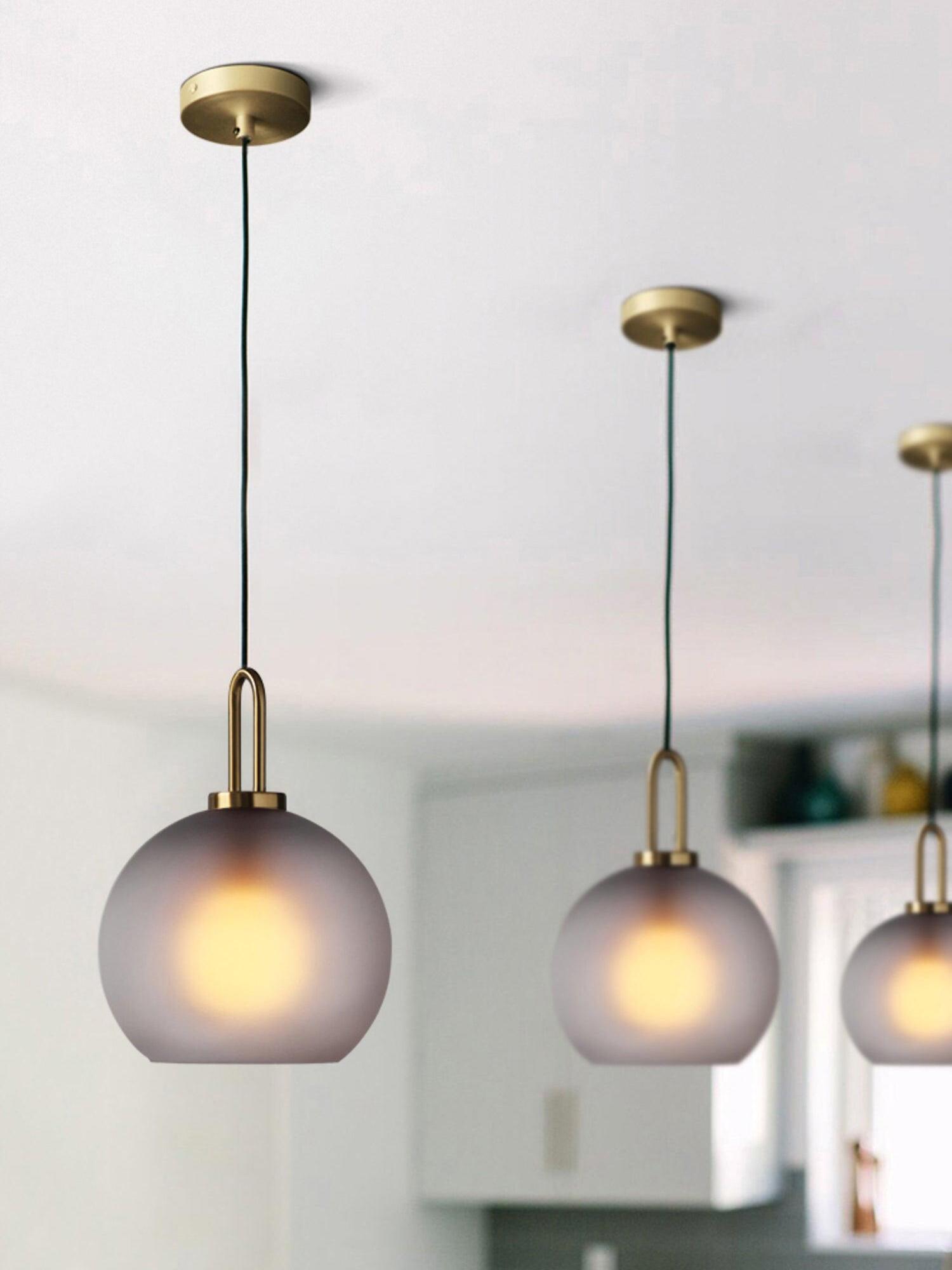 Row of frosted globe pendants with round canopies