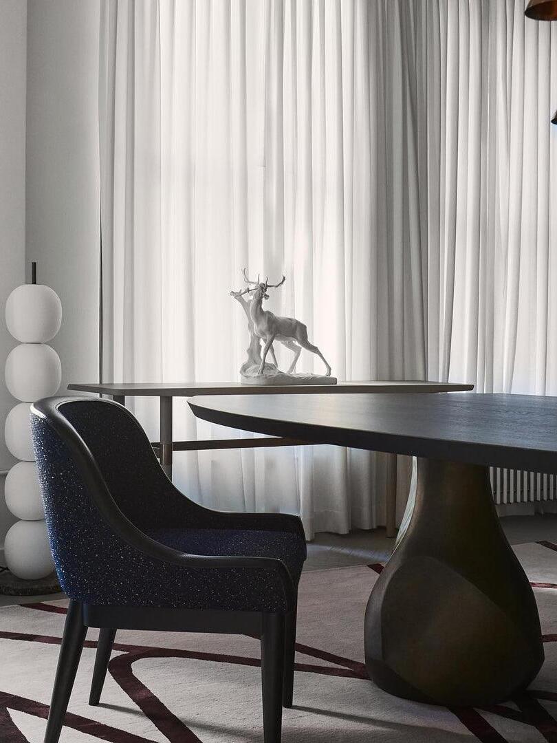 Unlit white globe lamp beside dining table