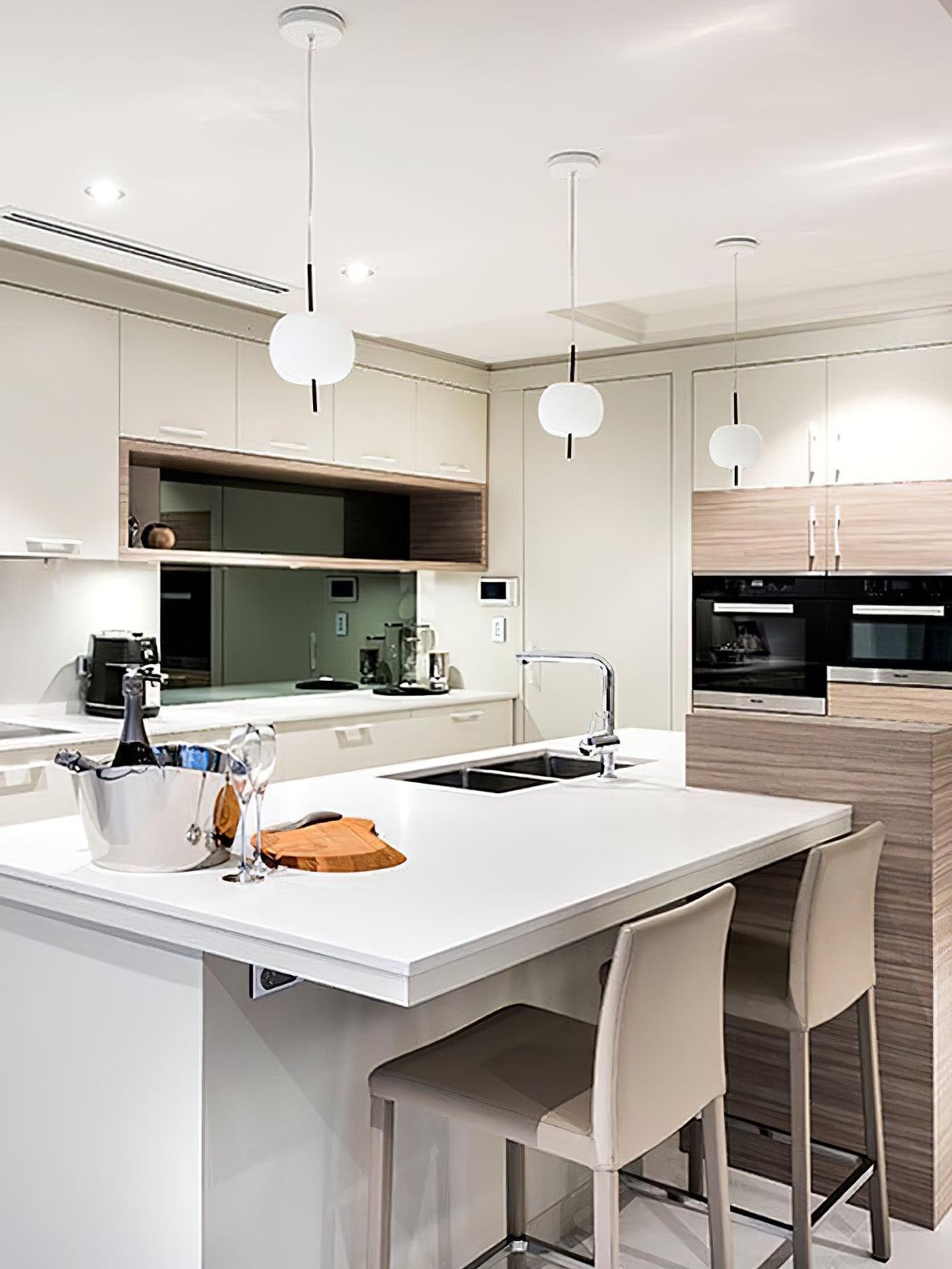 White pendants over a kitchen island