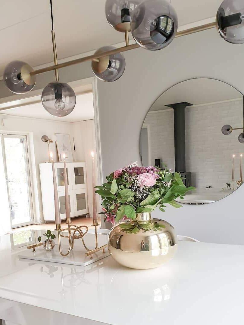 Glass globes and brass-coloured bar near a mirror