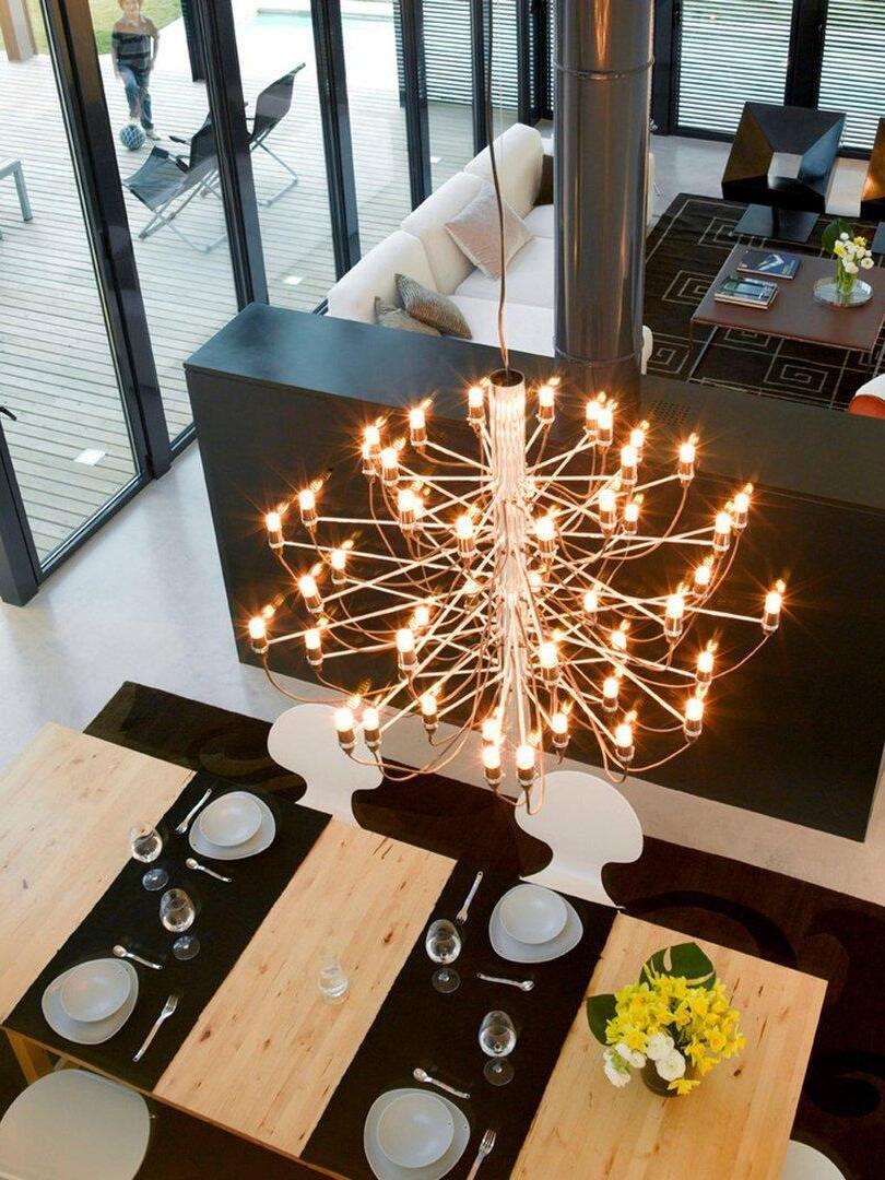 Overhead view of illuminated chandelier above dining tables