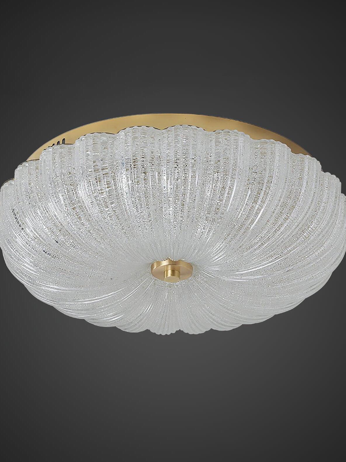 Unlit textured glass ceiling bowl with swirling ribs, a scalloped rim and gold-tone fittings on a gray background