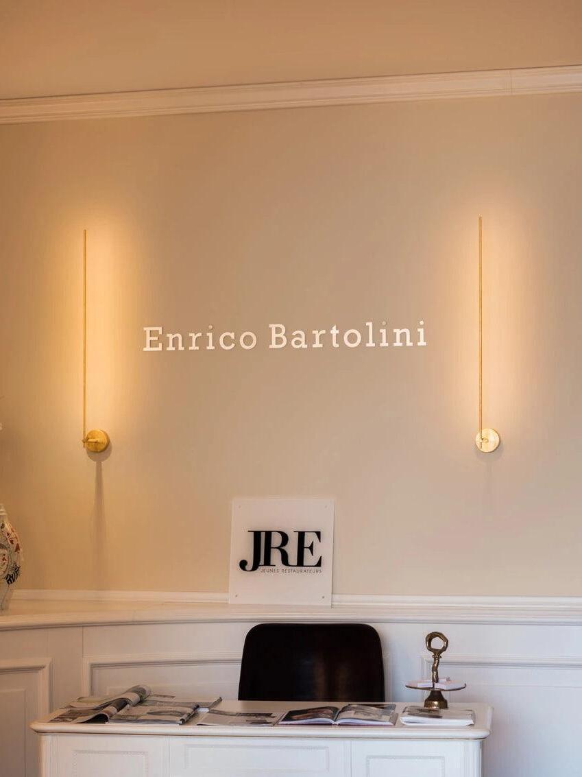 Two slim wall rods above a reception desk
