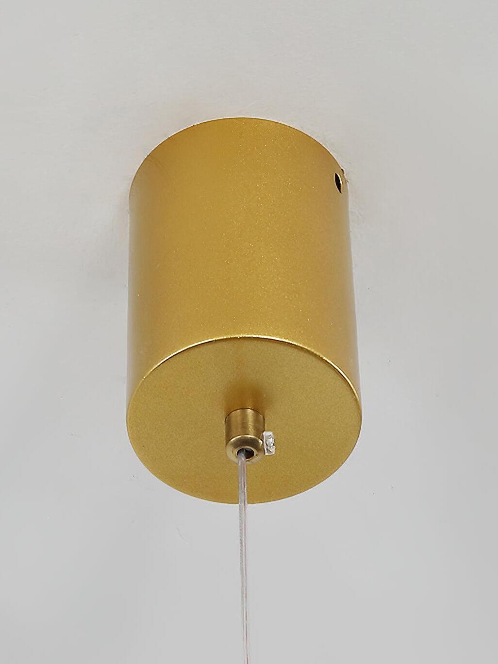 Close-up of the gold cylindrical ceiling canopy