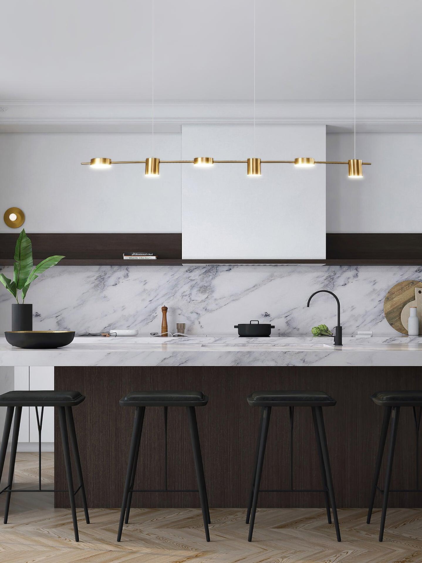 Gold linear light above a dark kitchen island