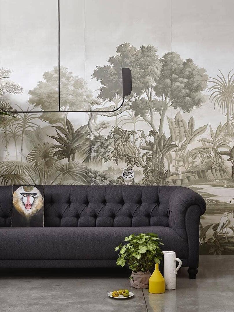 Black leaf-shield fixture above a sofa