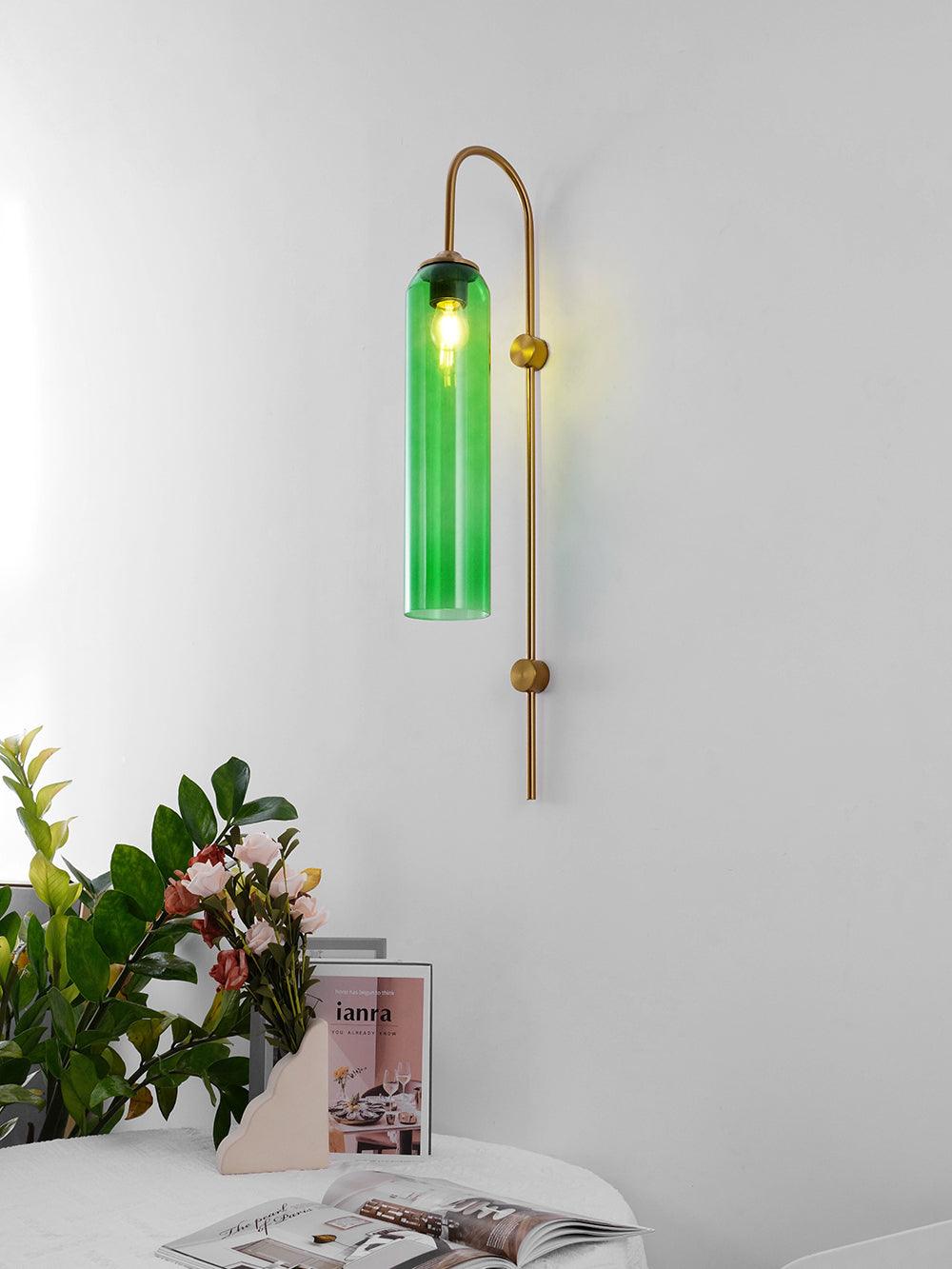 Illuminated green glass cylinder and gold-coloured fittings