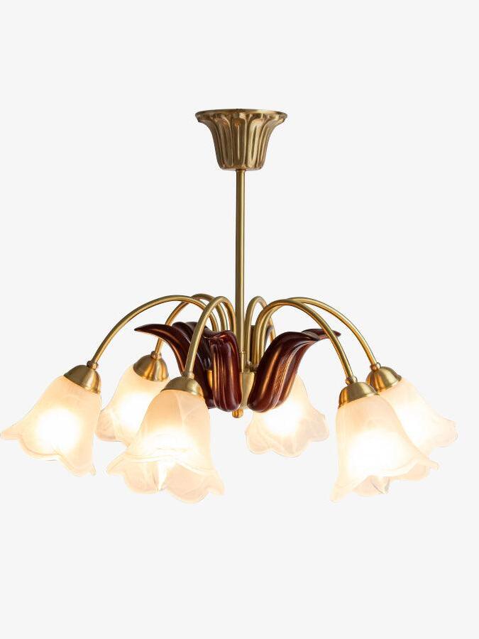 Lit brass-and-white flower chandelier isolated view