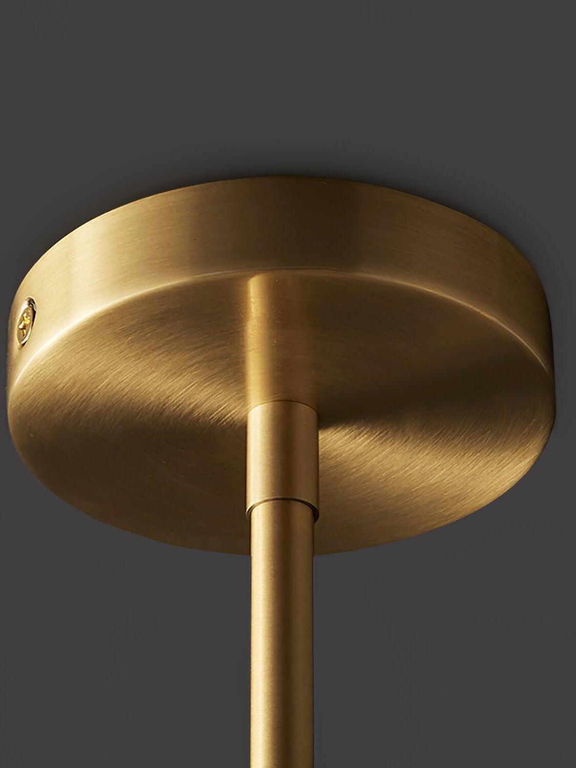 Close view of a round brushed brass-tone ceiling canopy, stem joint and recessed side screw