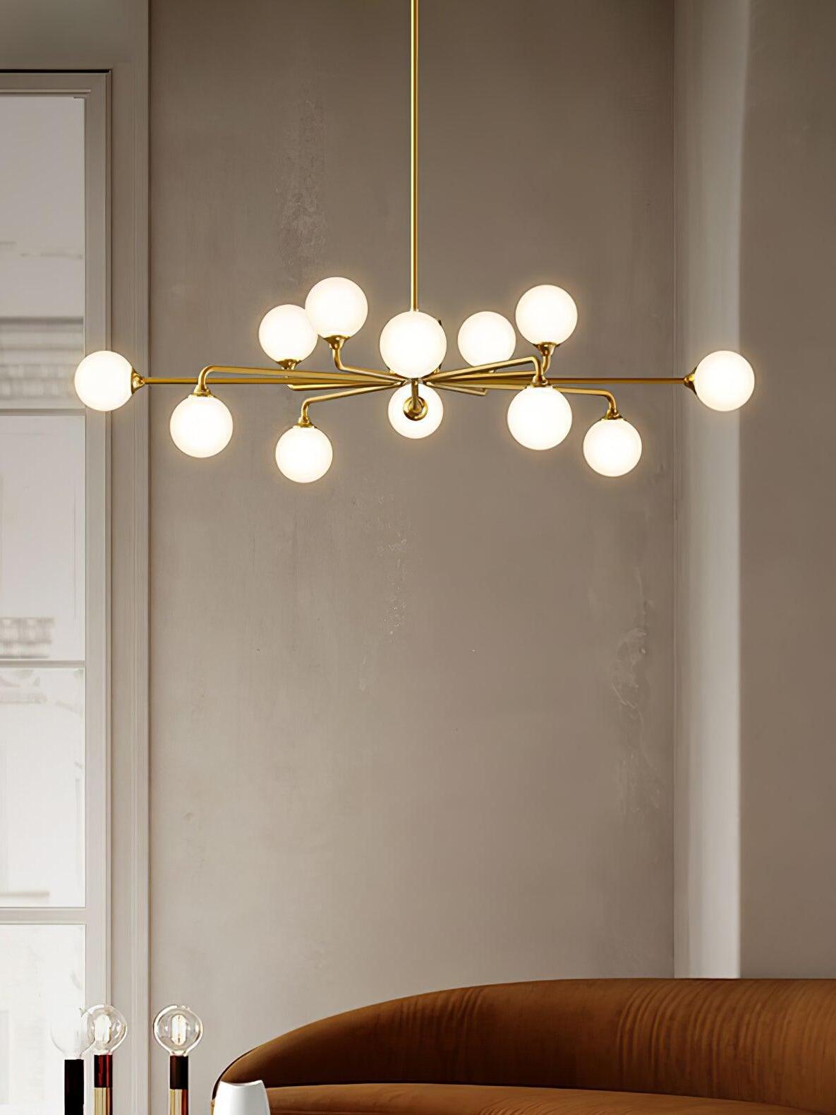 Brass globe chandelier over lounge seating