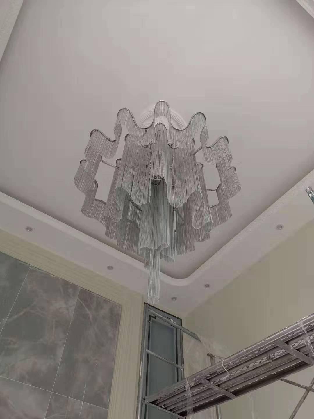 Large silver-coloured tiered fixture in a tall room
