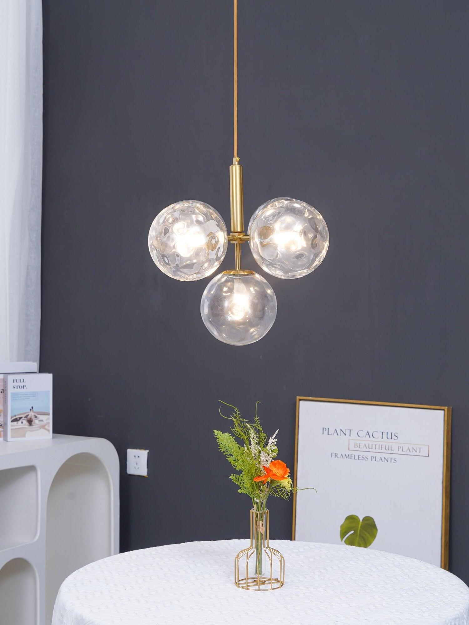 Clear glass globe cluster above a round table