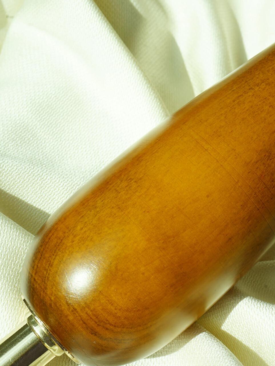 Close view of rounded brown lamp stem and gold-tone fitting