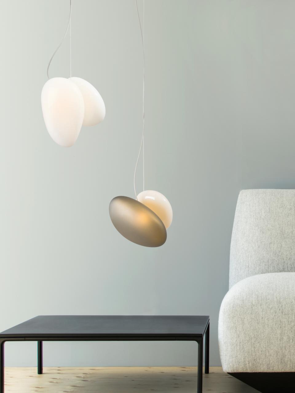 Two pebble pendants near a black low table