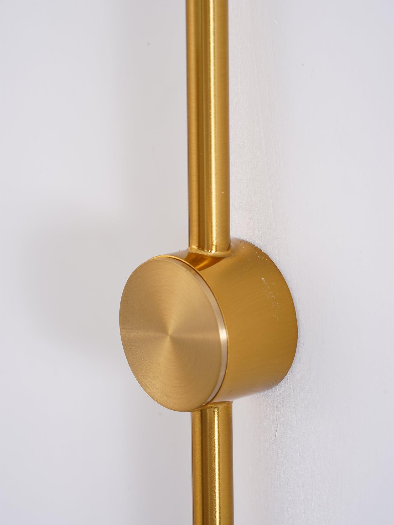 Round gold-coloured wall mount close-up