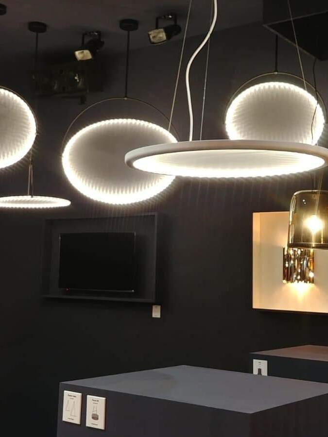 Several illuminated disc pendants in an interior display