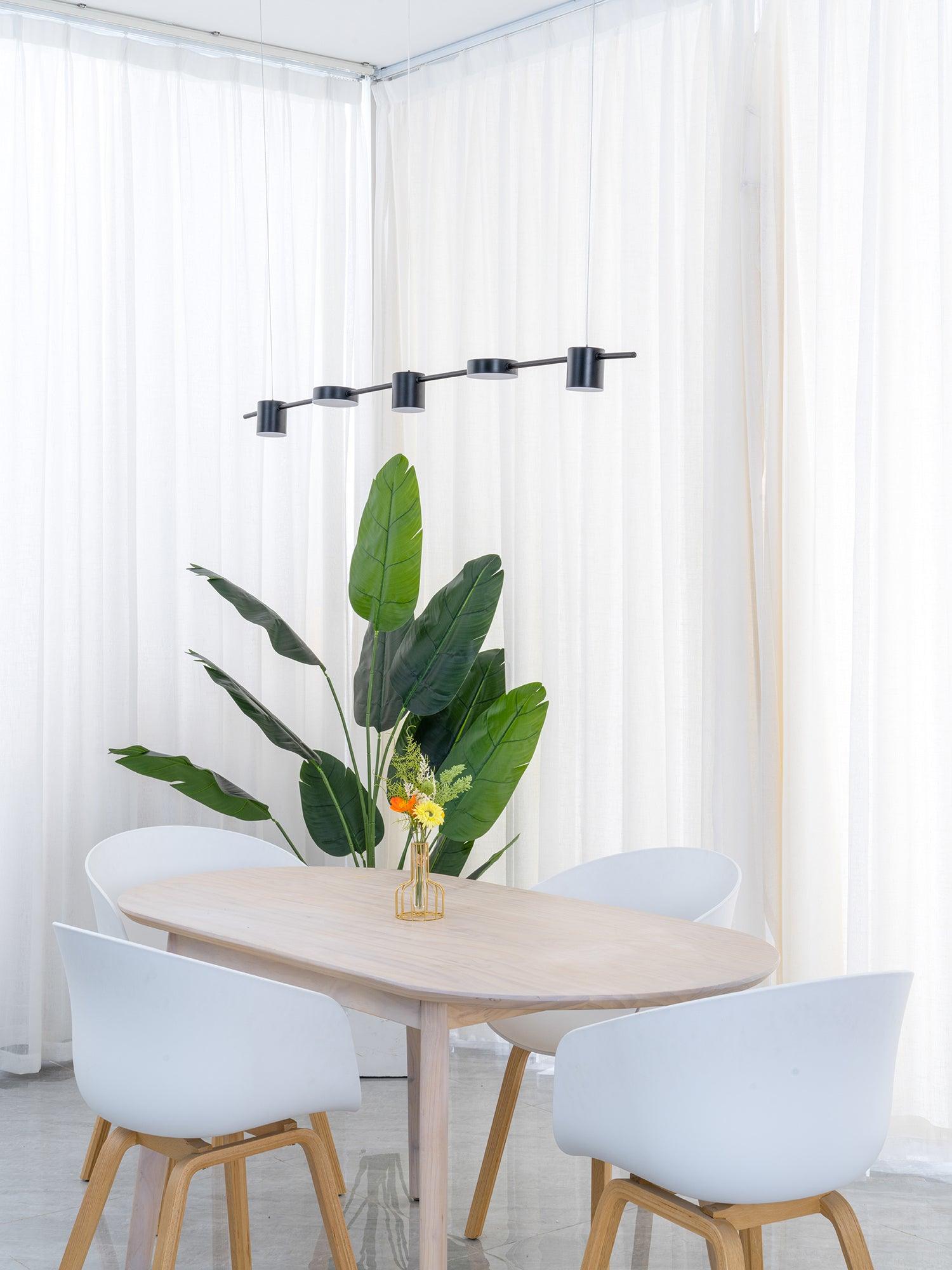 Black linear light above a pale round table