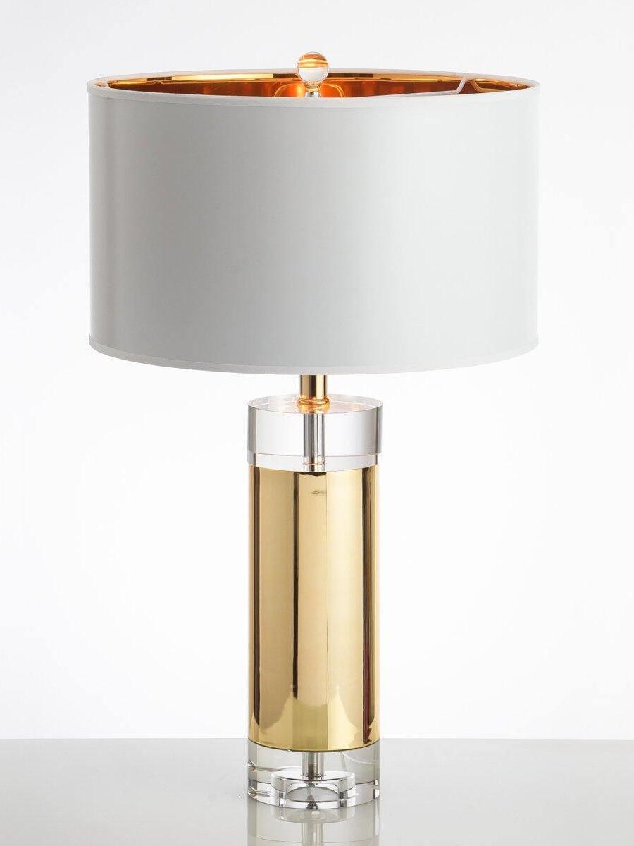 Gold-tone cylinder with clear top collar and base beneath white drum shade with gold interior