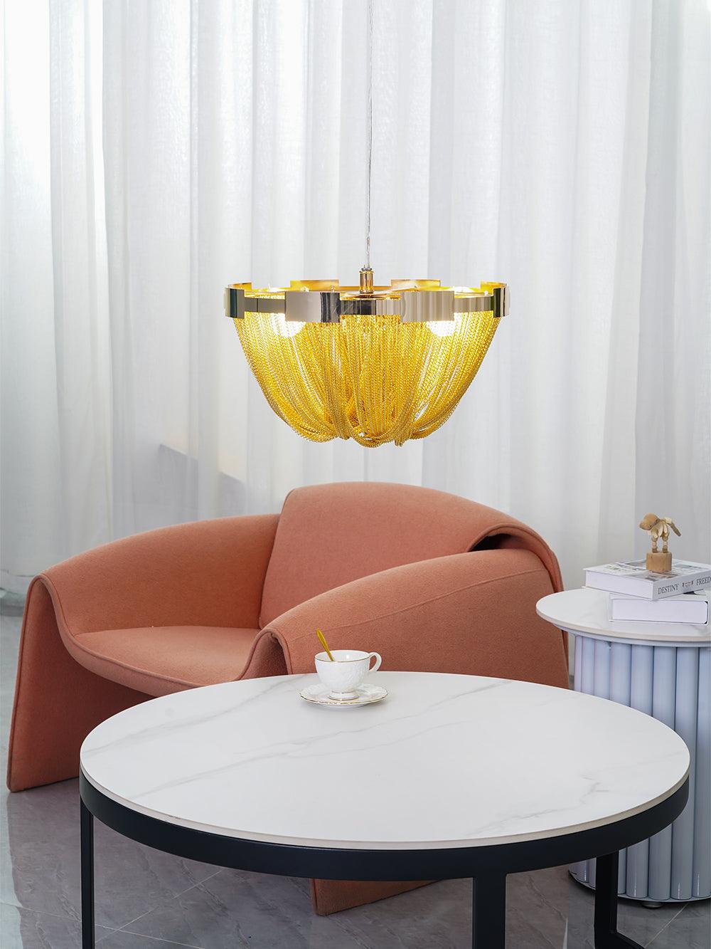 Gold-tone chain ceiling light above sofa and round table