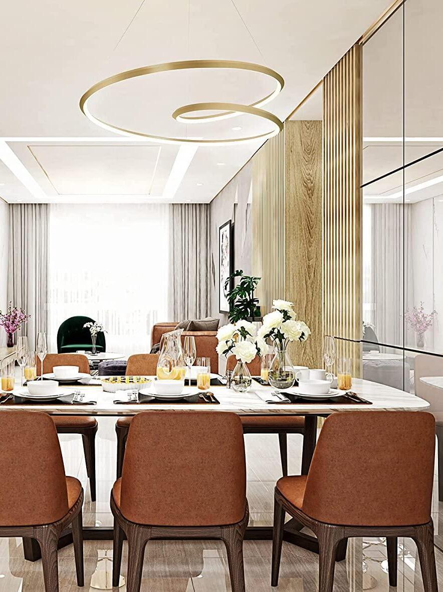 Gold loop fixture over a dining arrangement