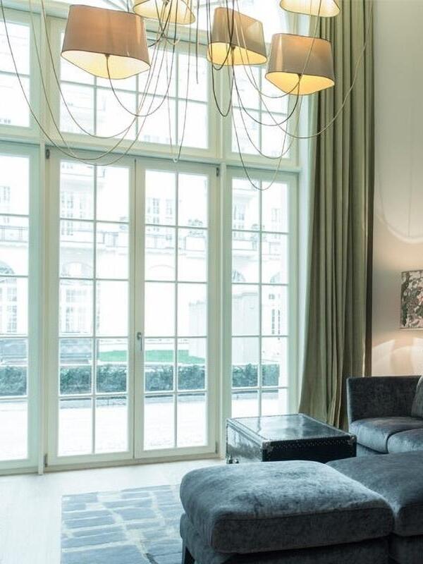 Multi-shade ceiling lighting near tall windows