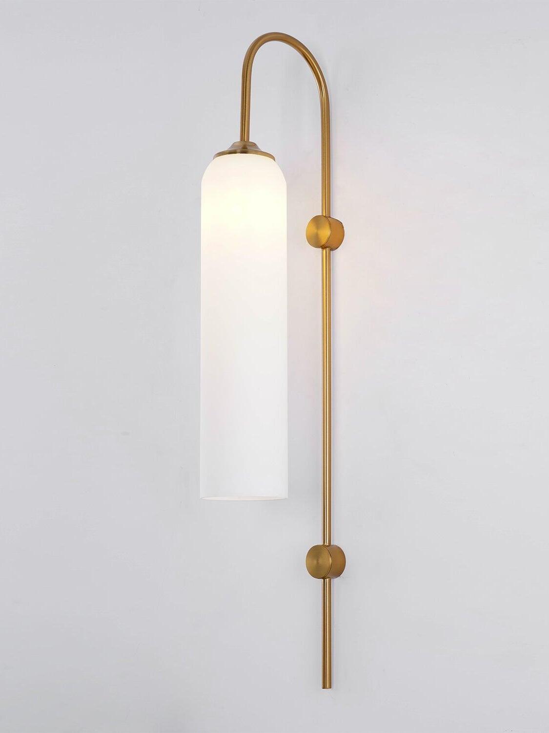 Illuminated white cylinder and gold-coloured wall fittings