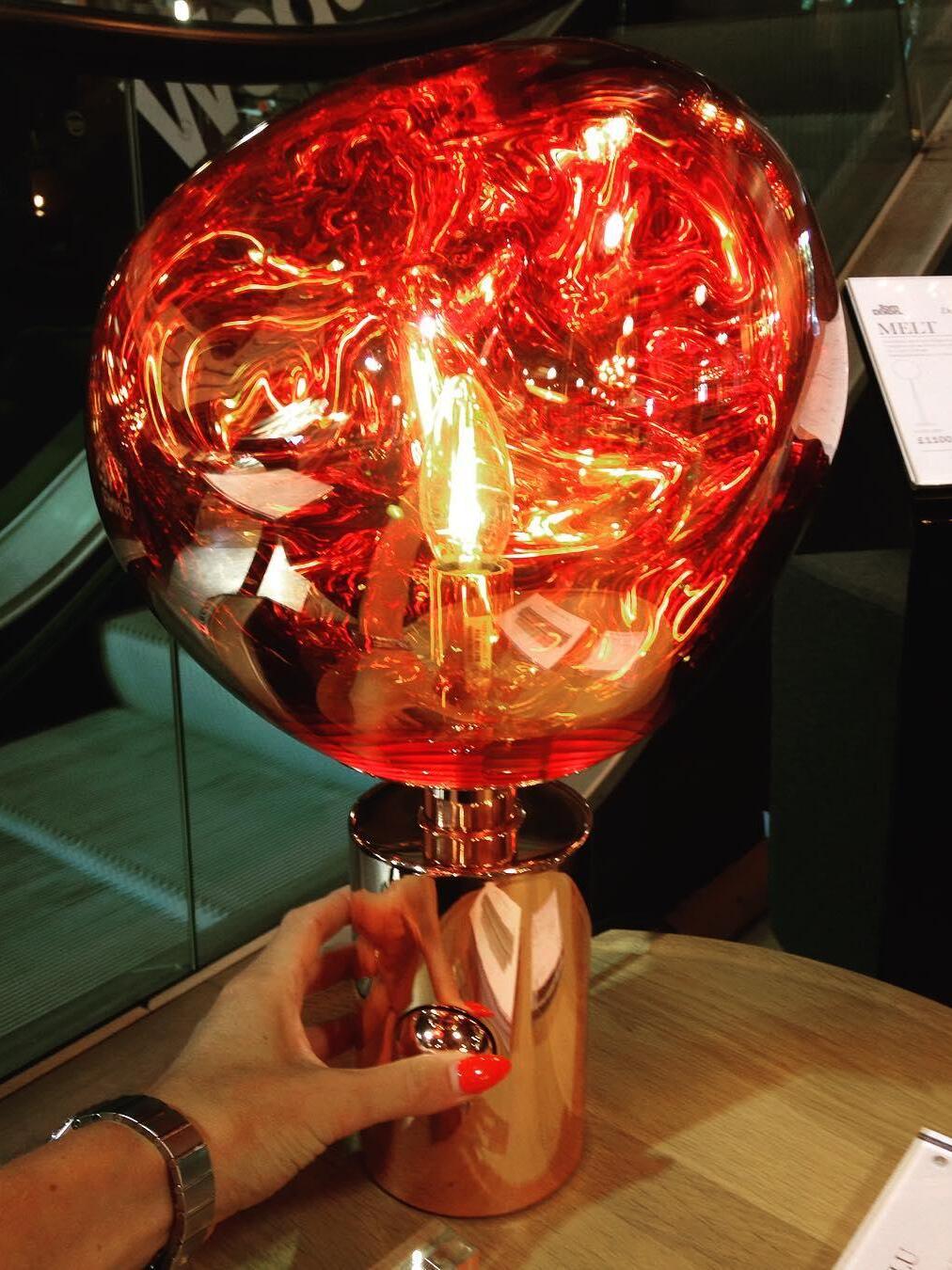 Hand beside a glowing Red Melt lamp