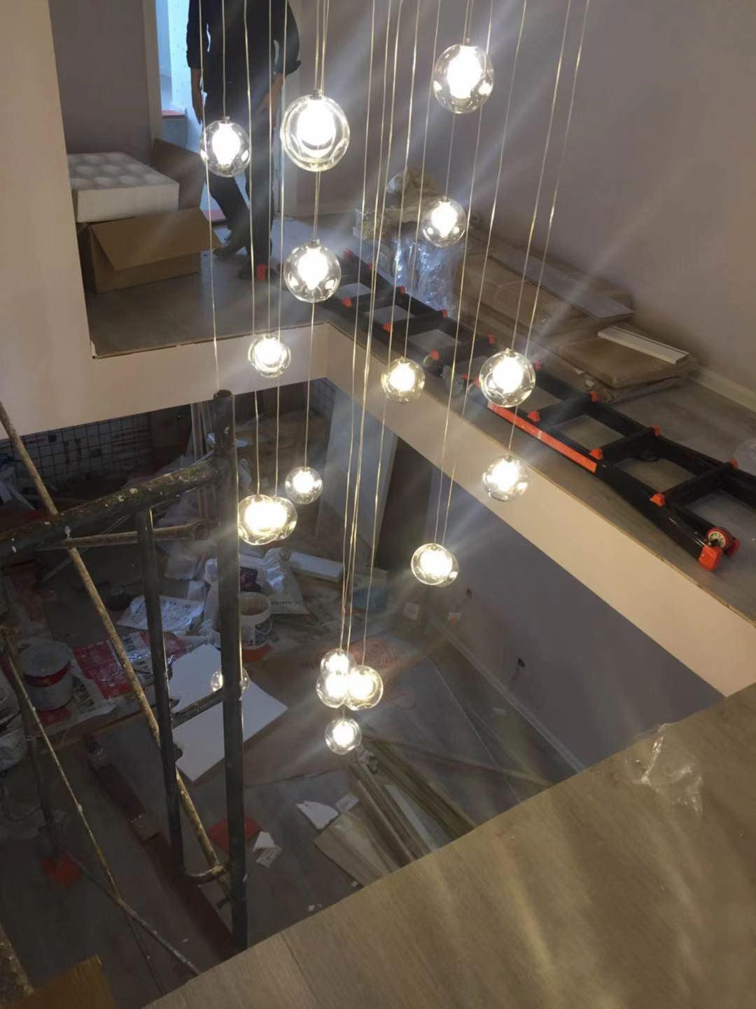 Globe pendants reaching into double-height stair void