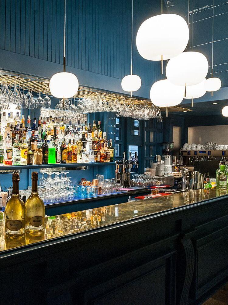 White globe pendants above a bar counter