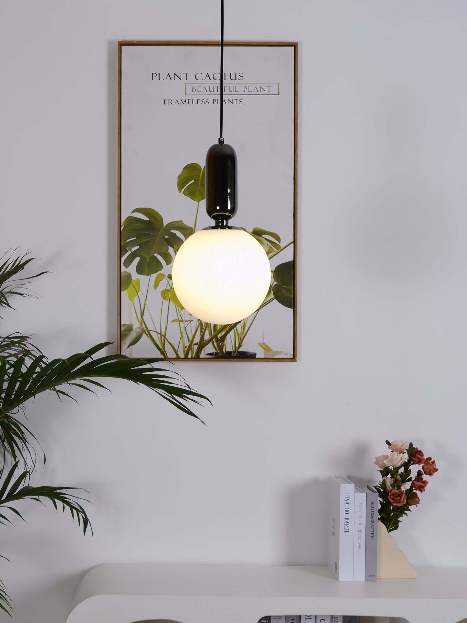 Lit globe with a black cap beside artwork