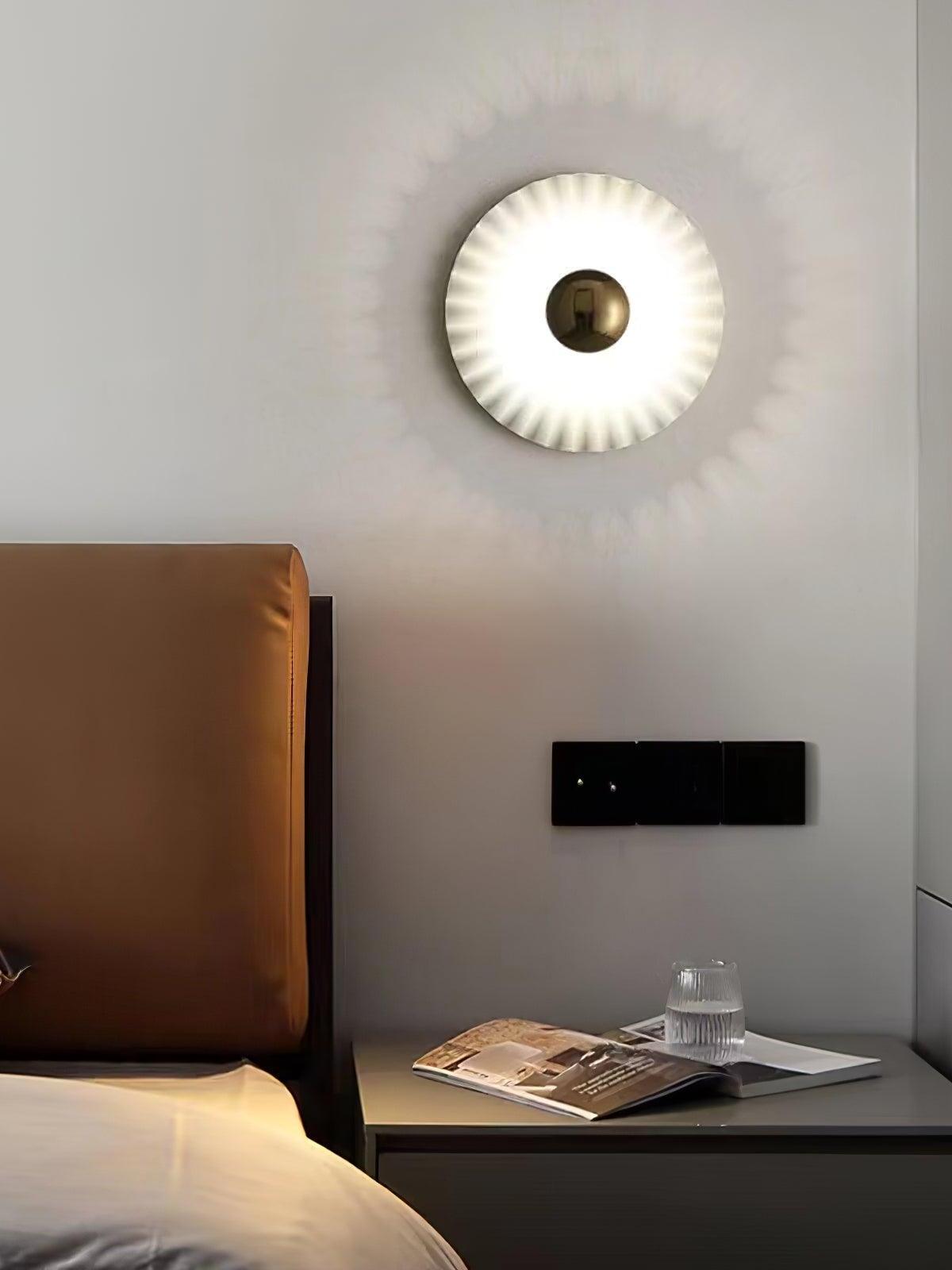 Single pleated wall disc with gold centre by bed