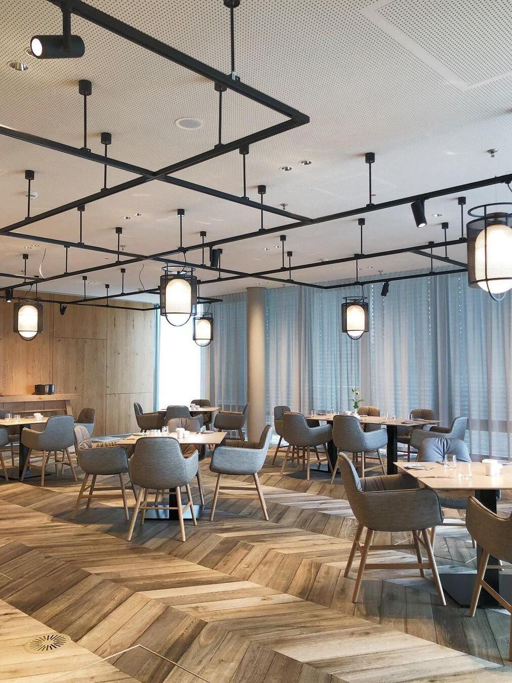 Multiple black lantern pendants across restaurant ceiling