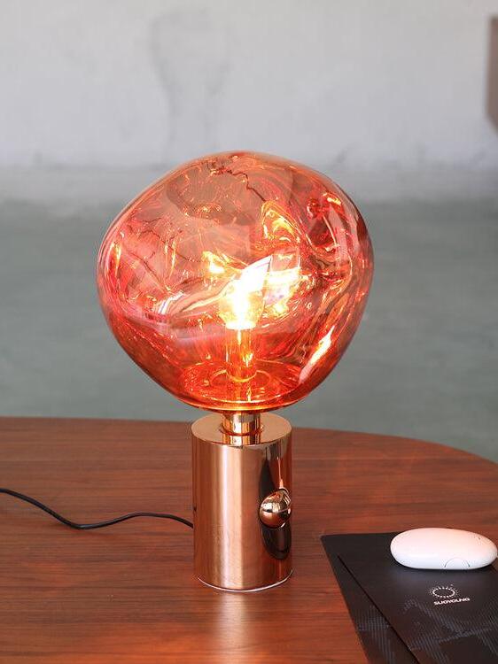 Glowing Red Melt lamp on a small table