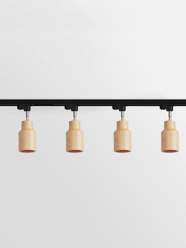 Four pale straight wooden spots on black bar