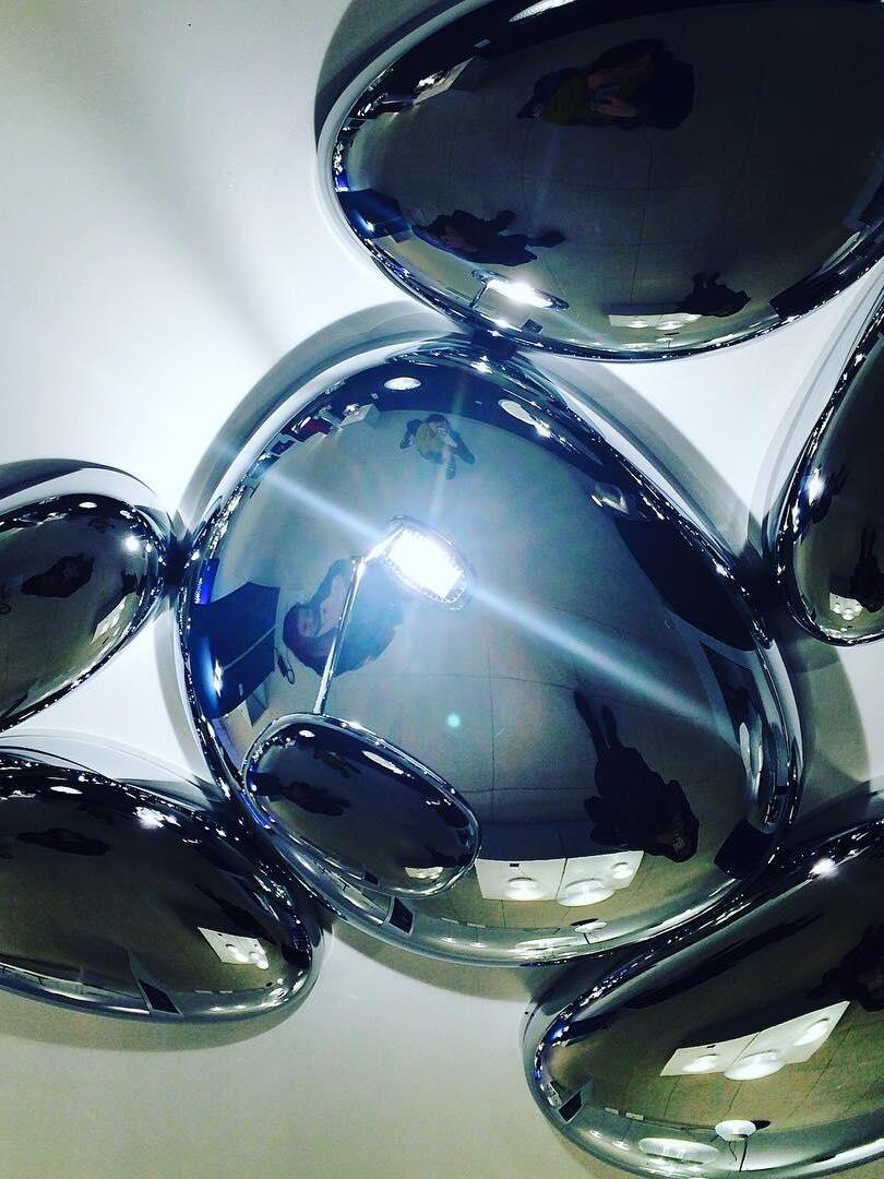 Close reflective pebble surfaces with blue-tinted room reflections