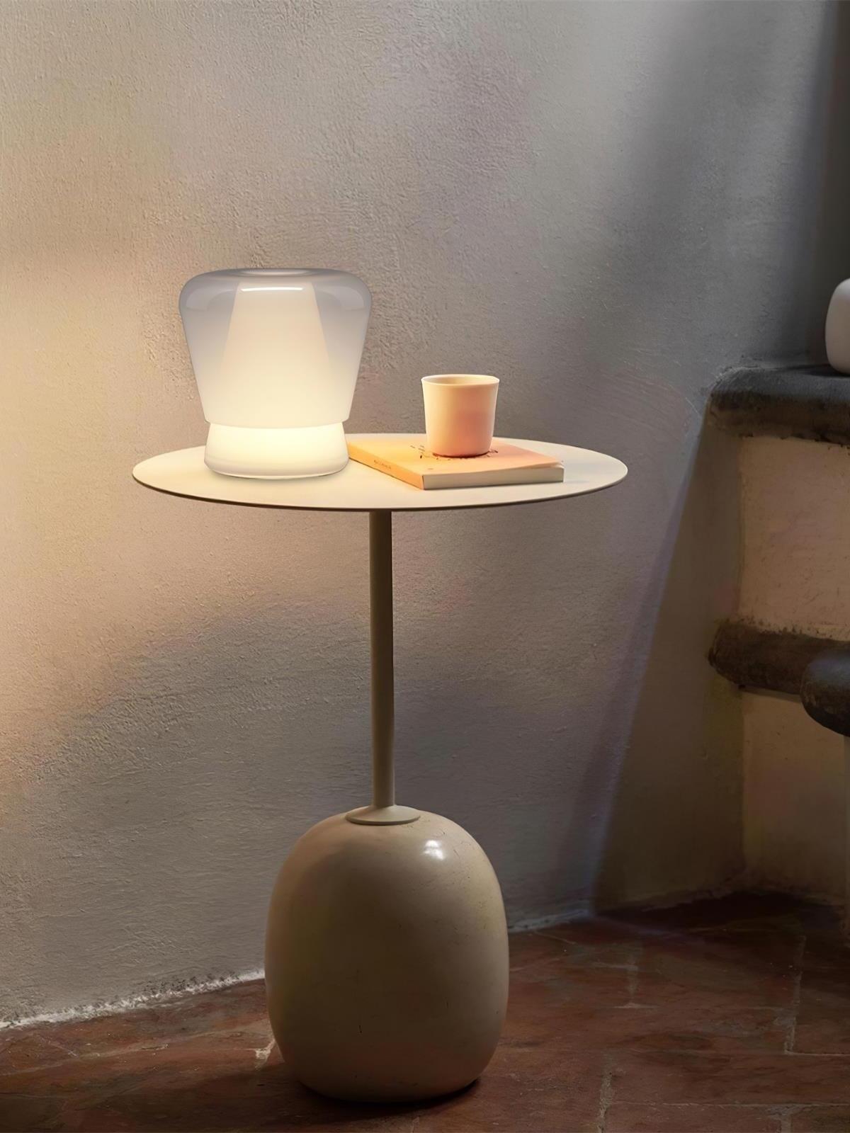 White Jumelle lamp on round side table with cup