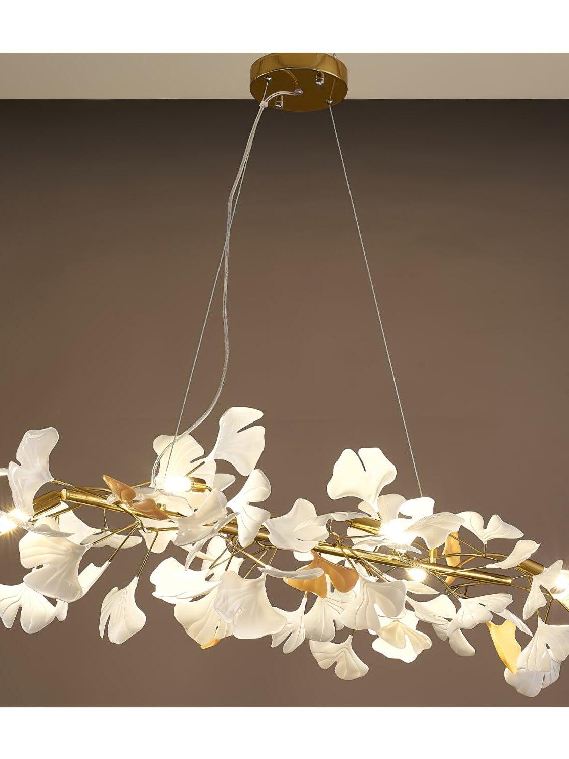 Close view of a gold-tone canopy and white ceramic leaf branches