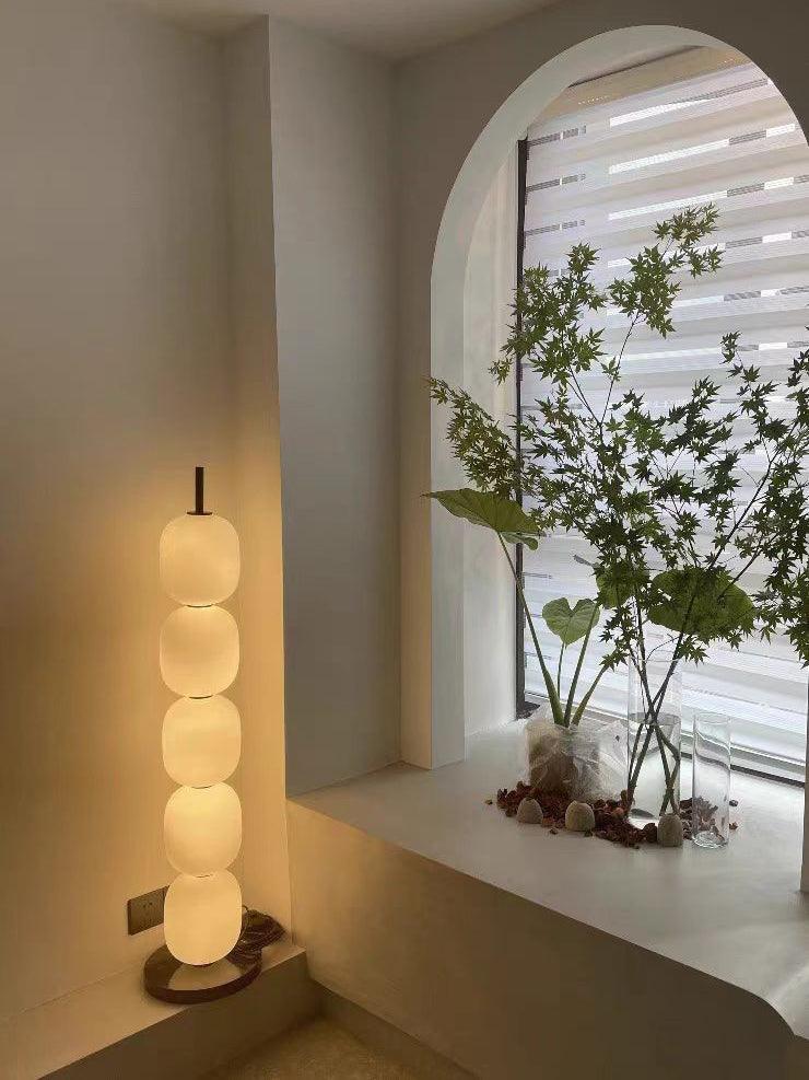 Five-globe lamp beside a window ledge
