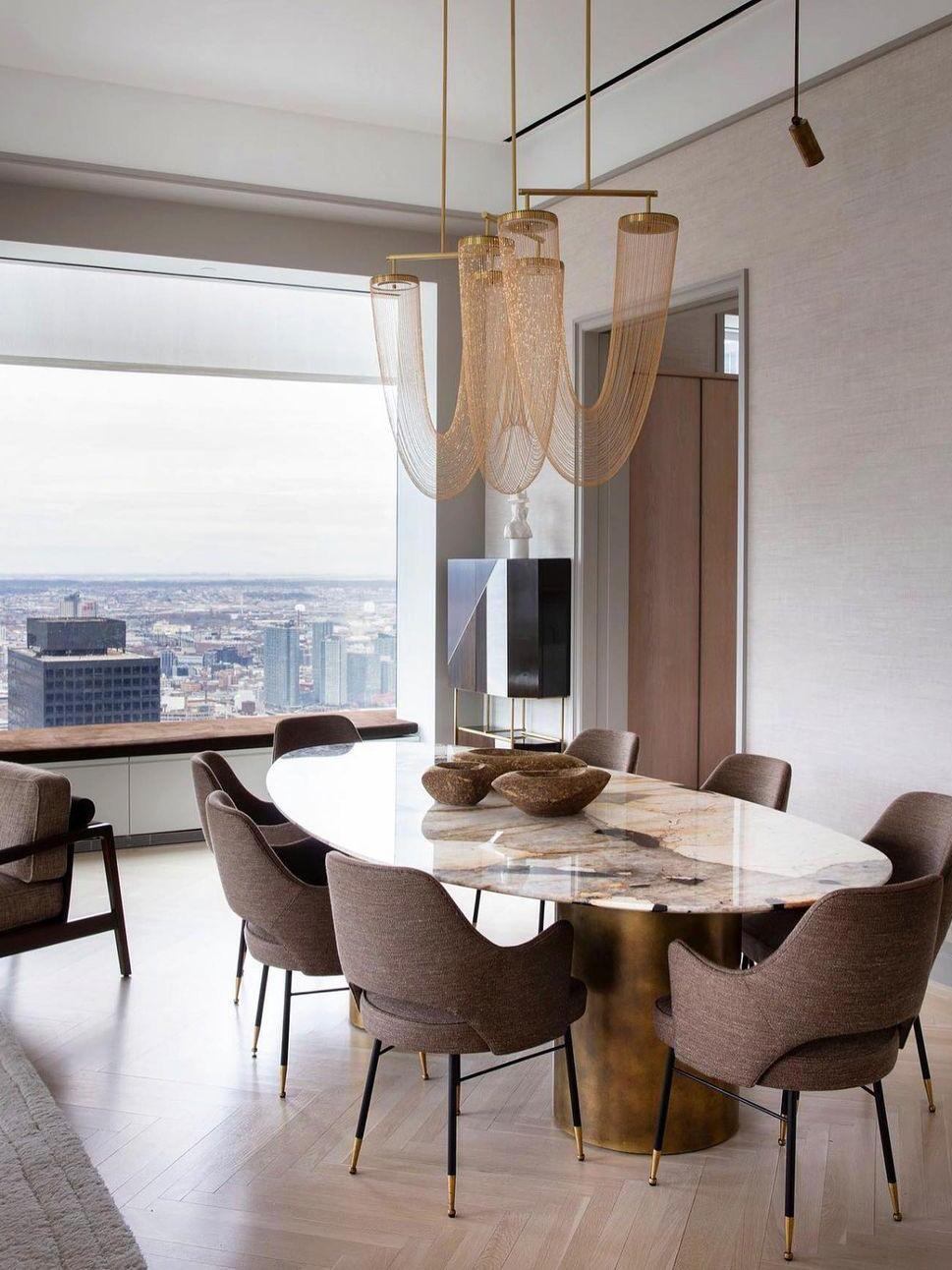 Metal chain fixture above a marble-patterned dining table