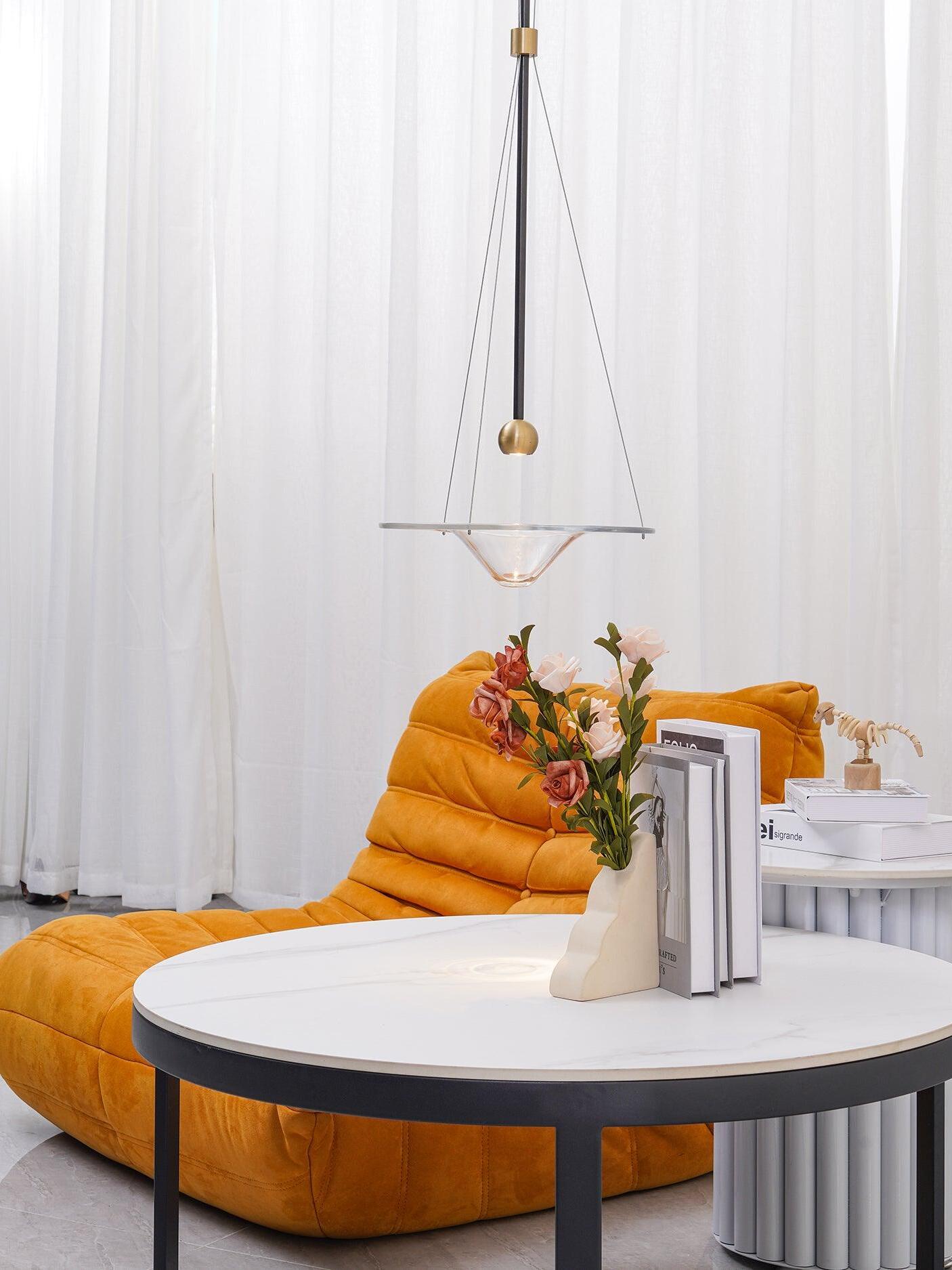 Single transparent disc pendant in pale living room
