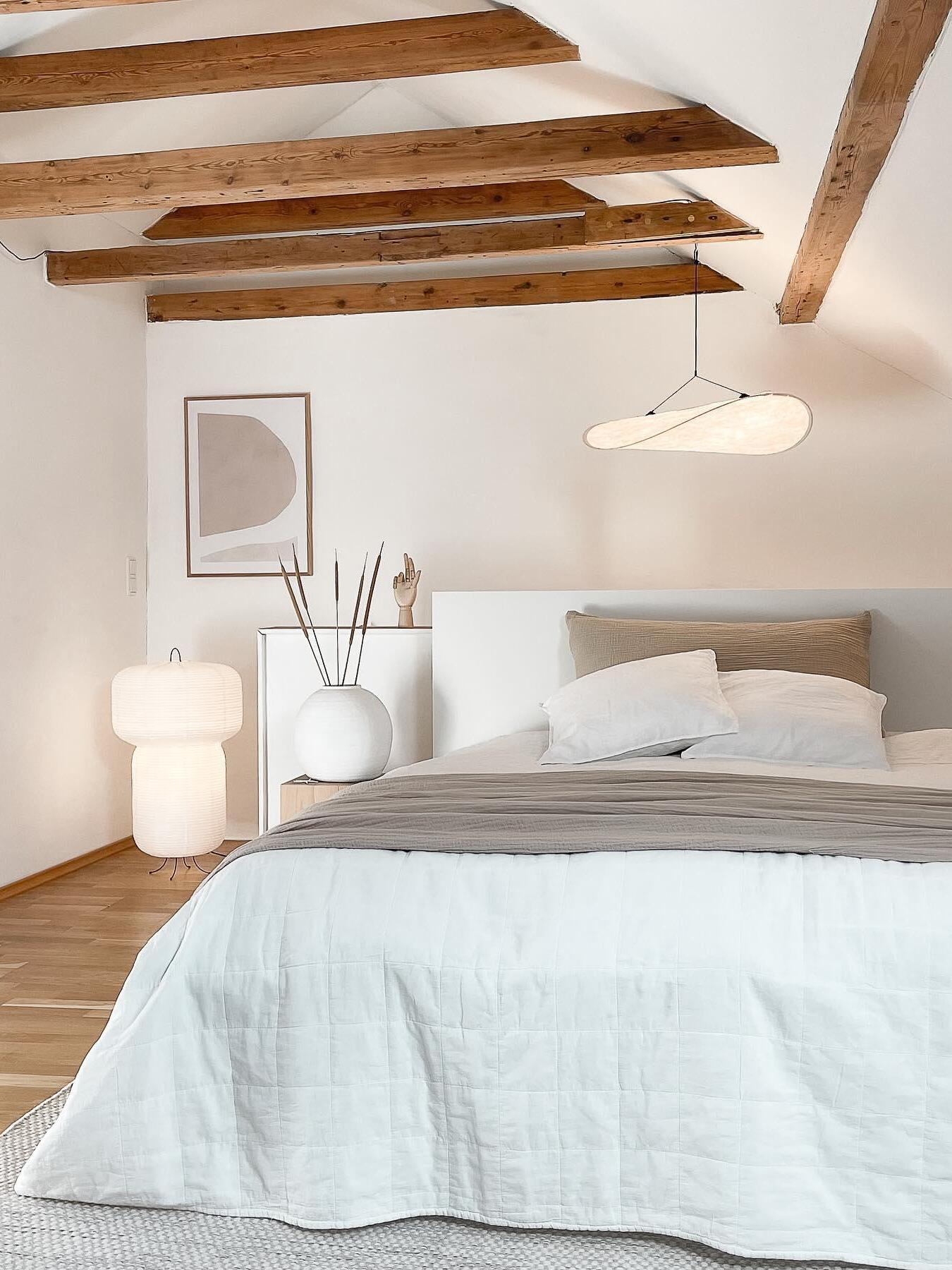 White cloud shade in a bedroom with wood beams