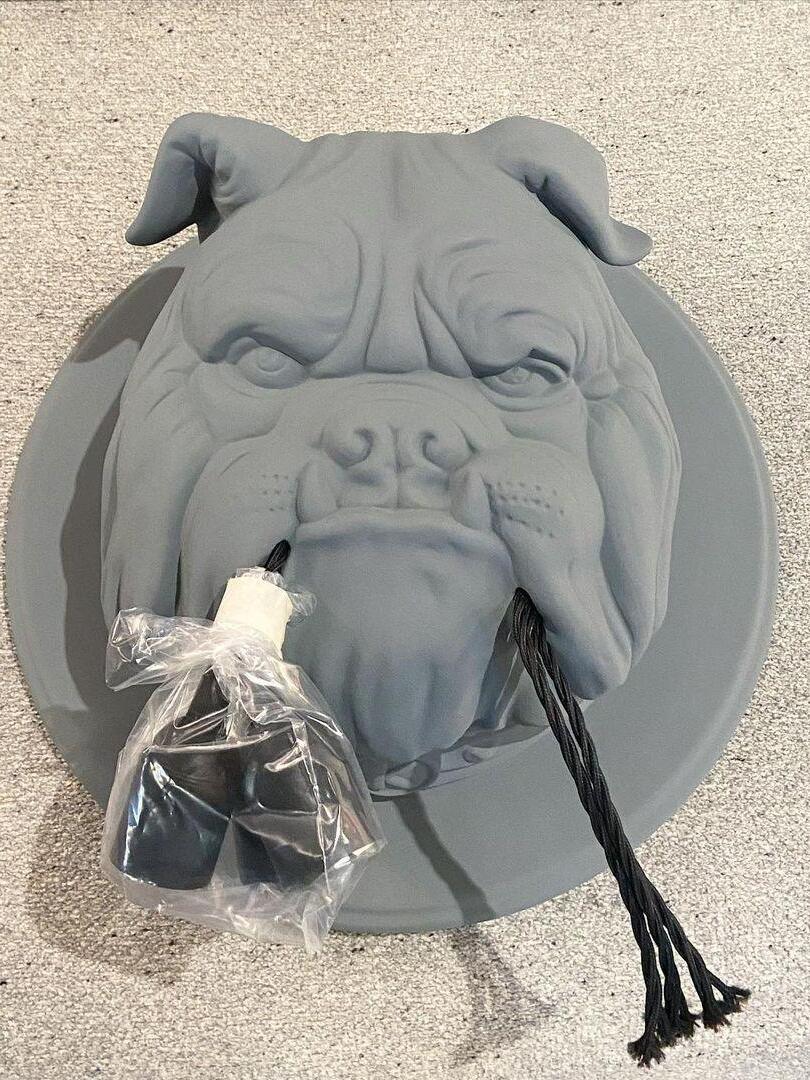 Grey bulldog fixture with bulb holders wrapped for packing