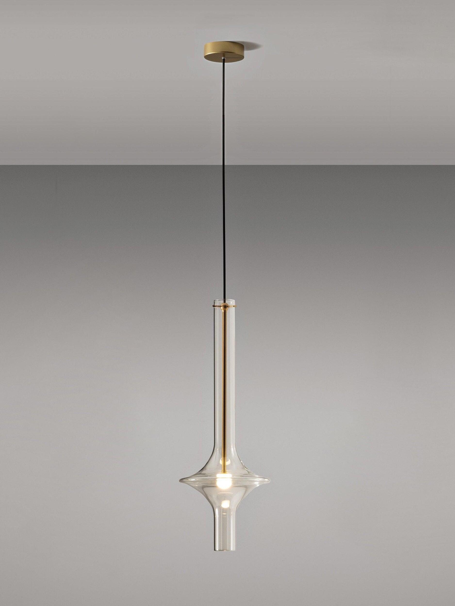 Single clear flared glass pendant with gold-tone central stem and round gold-tone ceiling canopy on a black cable