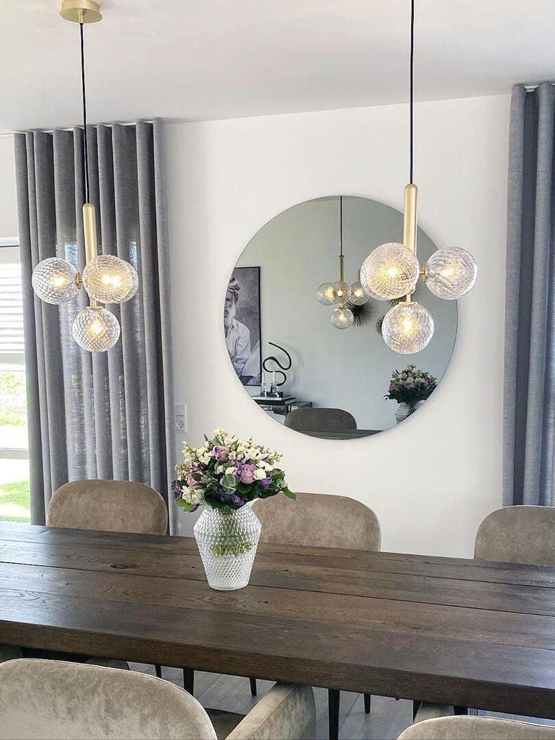 Two clear-glass clusters above a wood table