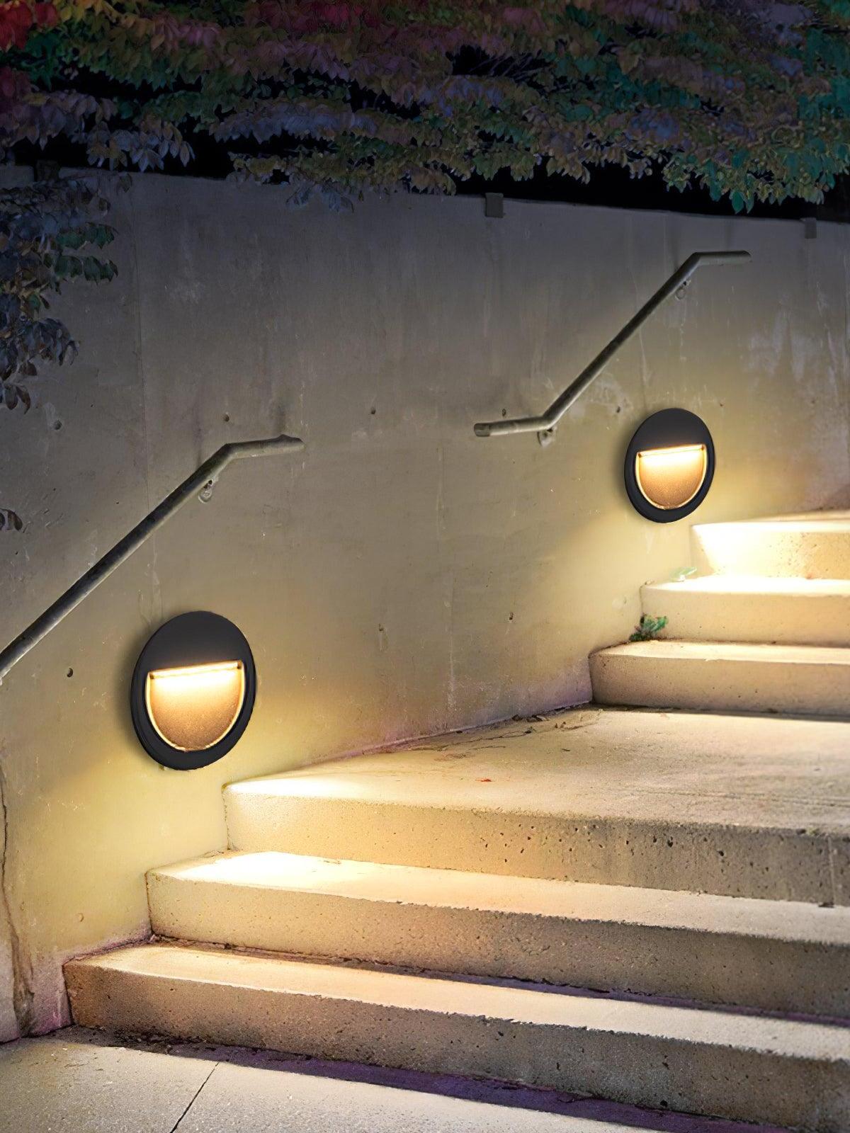 Two round lights along exterior stair wall
